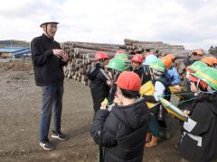 児童に木材について説明する木下社長（左）