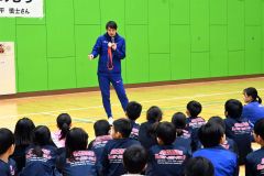 北京五輪の銀メダルを手に子どもたちの質問に答える高平さん