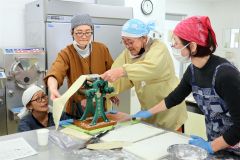 製麺機を使って中華麺づくりに挑戦する受講者ら。左から２人目は浦木さん