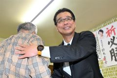 初当選を果たし、支持者らと握手を交わす田中氏（２１日、午後９時半ごろ、広尾町内の選挙事務所で。金野和彦撮影）