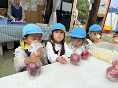 リンゴを頬張る園児たち（北明やまざと幼稚園提供）