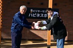 （左）稲葉園長に目録を手渡す寮祭チャリティーバザーの（右）芳賀皓太隊長