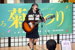 弾き語りする幕別清陵高校３年のＹＵＡさん。透き通るような歌声に観客は魅了されていた。