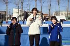 女子１０００メートルの表彰で満面の笑顔で写真に納る（左から）２位の奥秋静子、優勝の松島未来、３位の笹渕和花（金野和彦撮影）