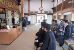 宮城県仙台市宮城野区にある専能寺の住職から震災当時の話を聞く十勝組の関係者ら（２０１５年１０月、同組提供）