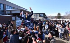 仲間から胴上げをされる卒業生（１９日、午前１１時４５分ごろ。金野和彦撮影）