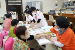 ハンドセラピーを受けて笑顔になる参加者