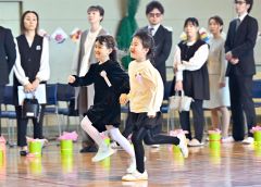 新入学生同士で手をつなぎ体育館を走り回る（音更、塩原真撮影）