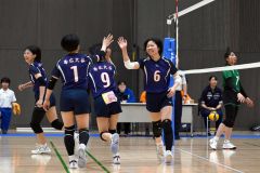 【女子決勝トーナメント１回戦・帯大谷―岩見沢緑陵】第１セット、帯大谷の中山絢奏（紺色ユニホーム、右（６））がスパイクを決め笑顔でハイタッチをい交わす（金野和彦撮影）