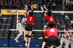 【女子準々決勝・帯南商―旭川志峯】第１セット、スパイクを打つ帯南商の林梨花主将（白青ユニホーム、左）＝金野和彦撮影