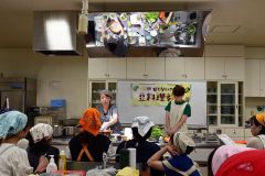 甘くない豆料理を実演した谷口さん（左）