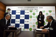 観光振興に関する協定書に押印する小野町長（右）とＪＡＦ帯広支部の石原支部長（左）