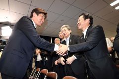 支援者と握手を交わす岩本氏(左)