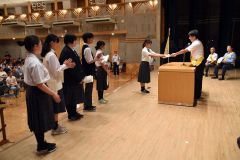 町交通安全協会の朝倉会長から賞状を受け取る交通安全スローガンコンクール入賞者