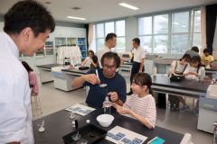 人工クラゲ作りに挑戦する親子ら（左が佐藤教諭）