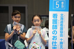 看給料を受け取って喜ぶ子ども(30日午前10時30分ごろ。佐藤有将通信員撮影)