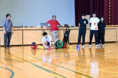 秋山教授（中央奥）や田中特任講師（左）が見守る中。エアロケット打ち上げに臨む生徒たち