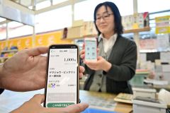 １０月から始まったデジタルどんぐりスタンプ。右奥はポイント付与の手順を紹介する太田店舗部長