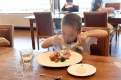 ナイフとフォークを使いフルコースを味わう園児