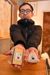 銀賞を受賞したチーズ２品を手にする本間代表