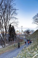 津波に備えた訓練で、自宅から高台の安全な場所まで徒歩で避難する音調津地区の住民ら(13日午前9時過ぎ、広尾町音調津、石原秀樹通信員撮影)